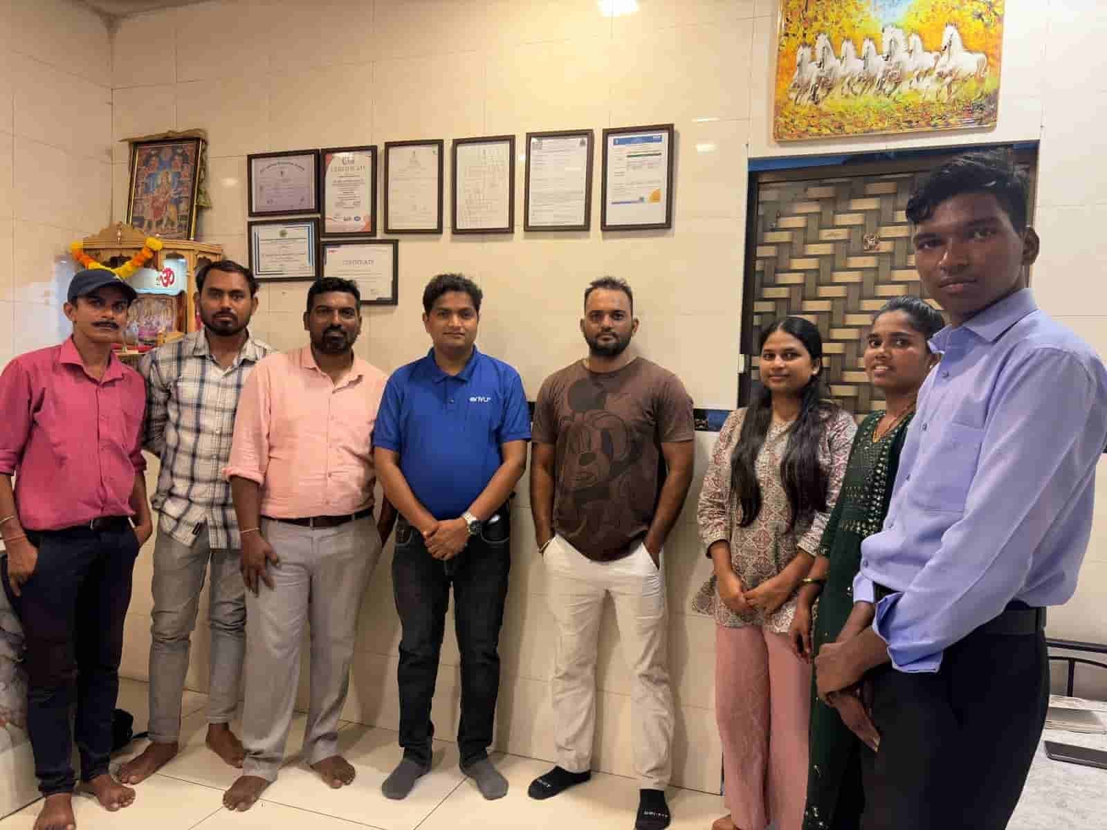 The SSD Pest Control team standing together in the Dahisar office in front of the company certificates